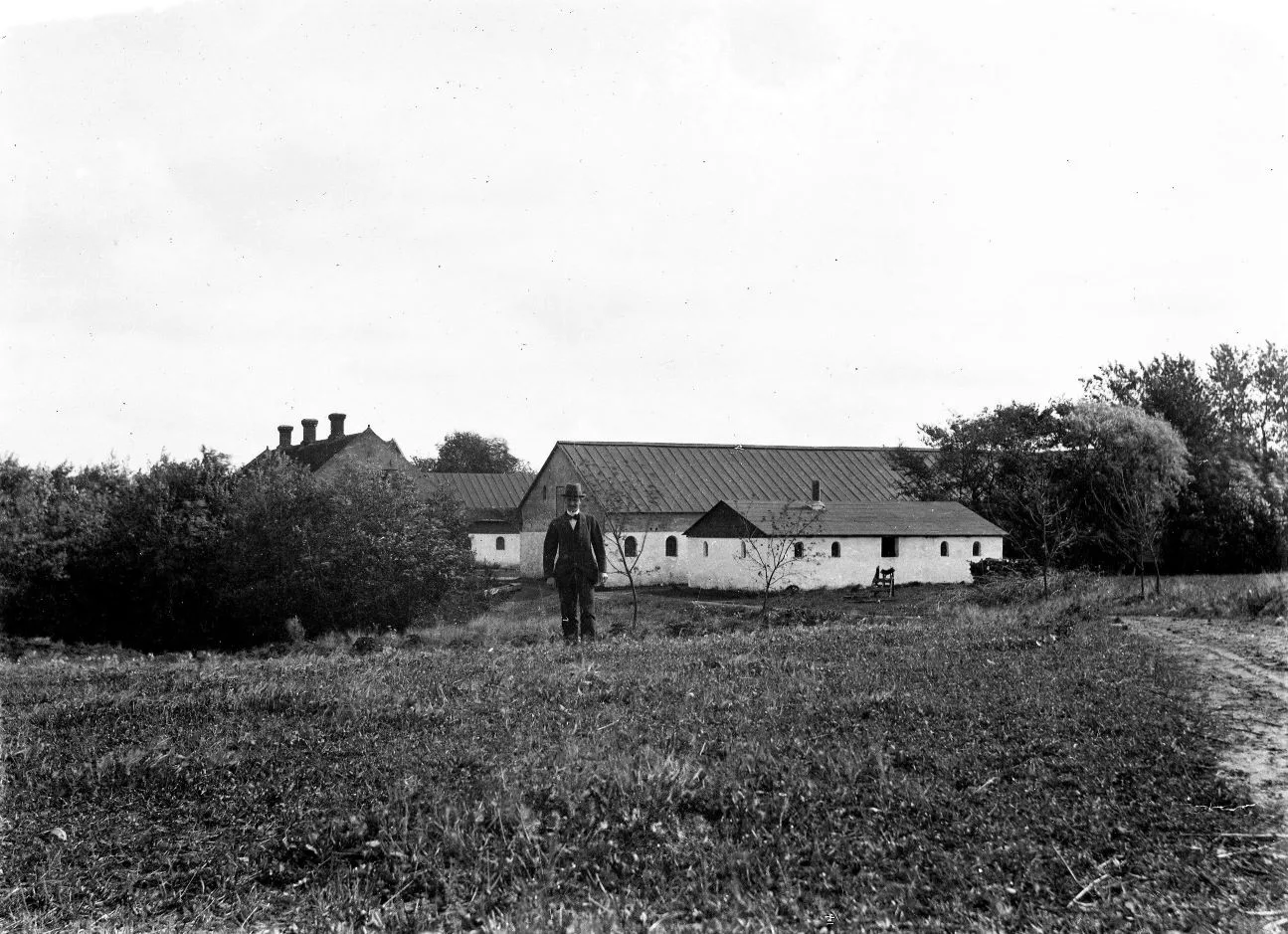 14183.3.8 114183.3.8 Gården Ulriksminde, Hallevej 3. Brædstrup. Samme gård ses på billede 3.13 og 3.2. Billedet er taget på den vestlige side af gården og det er August der ses stående foran gården.